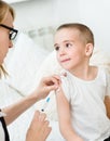 Happy little boy receiving injection or vaccine Royalty Free Stock Photo