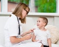 Happy little boy receiving injection or vaccine Royalty Free Stock Photo