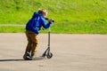 Happy little boy riding scooter, active kids Royalty Free Stock Photo