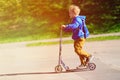 Happy little boy riding scooter, active kids Royalty Free Stock Photo