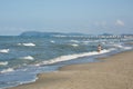 Happy little boy running far away in water along the sea beach Royalty Free Stock Photo