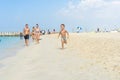 Happy little boy running on sand tropical beach. Positive human emotions, feelings, joy. Funny cute child making vacations and enj Royalty Free Stock Photo