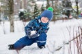 Happy little boy sculpts snowballs Royalty Free Stock Photo