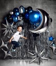 Happy little boy with silver and blue metallic balloons for birthday party with free text Royalty Free Stock Photo