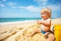 Little toddler point finger to sea sit on a beach Royalty Free Stock Photo