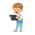 Happy little boy sitting and playing with digital tablet. Child and modern technology colorful cartoon character vector