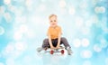 Happy little boy sitting on skateboard Royalty Free Stock Photo