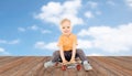 Happy little boy sitting on skateboard Royalty Free Stock Photo