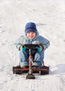 Happy little boy sledging at sleig