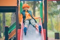 Happy little boy slides down the slide at the children& x27;s playground Royalty Free Stock Photo