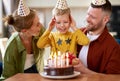 Portrait of happy child boy celebrating birthday with young parents at home Royalty Free Stock Photo