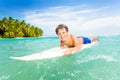 Happy little boy swim on surfing board in the sea Royalty Free Stock Photo