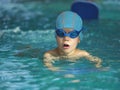 Happy little boy swimming in an indoor pool Royalty Free Stock Photo