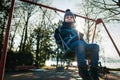Happy little boy on swing in beautiful winter day have fun Royalty Free Stock Photo