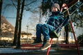 Happy little boy on swing in beautiful winter day Royalty Free Stock Photo