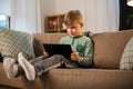 Happy little boy with tablet computer at home Royalty Free Stock Photo
