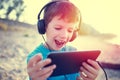 Happy little boy with tablet laughing outdoor vintage