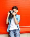 Happy little boy teenager with retro vintage camera in city Royalty Free Stock Photo