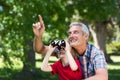 Happy little boy using binoculars with his father Royalty Free Stock Photo