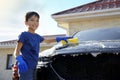 Happy little boy washing car at backyard Royalty Free Stock Photo