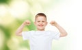 Happy little boy in white t-shirt flexing biceps Royalty Free Stock Photo