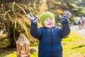 Happy little boy in winter clothes waving hands Royalty Free Stock Photo