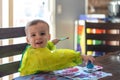 Cute toddler boy playing with paints at the kitchen table Royalty Free Stock Photo