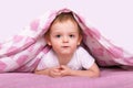 Little caucasian boy hiding under pink blanket. Royalty Free Stock Photo