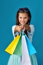 happy little caucasian child girl holds many shopping bags Royalty Free Stock Photo