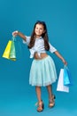 happy little caucasian child girl holds many shopping bags Royalty Free Stock Photo