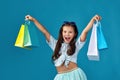 happy little caucasian child girl holds many shopping bags Royalty Free Stock Photo