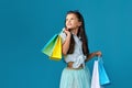 happy little caucasian child girl holds many shopping bags Royalty Free Stock Photo