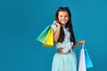 happy little caucasian child girl holds many shopping bags Royalty Free Stock Photo