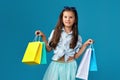 happy little caucasian child girl holds many shopping bags Royalty Free Stock Photo
