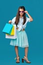 happy little caucasian child girl holds many shopping bags Royalty Free Stock Photo