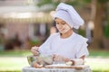 Happy little chef whipping eggs in a bowl