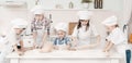 Happy little chefs preparing dough in the kitchen