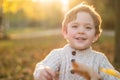 Happy little child baby boy laughing and playing in the autumn Royalty Free Stock Photo