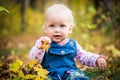 Happy baby girl laughing and playing in the autumn on the forest Royalty Free Stock Photo