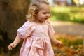 happy little child, baby girl laughing and playing in the autumn on the nature walk outdoors Royalty Free Stock Photo