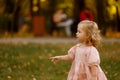 happy little child, baby girl laughing and playing in the autumn on the nature walk outdoors Royalty Free Stock Photo