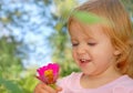 Happy little child, baby girl laughing and playing in Summer