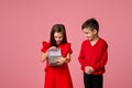 Happy little child boy gives smiling girl a gift box Royalty Free Stock Photo