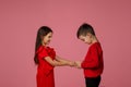 Happy little child boy gives smiling girl a gift box Royalty Free Stock Photo