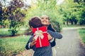 Happy little child boy gives smiling girl a gift box, making a surprise Royalty Free Stock Photo