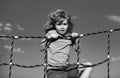 Happy little child boy on the web in outdoor playground. Kid enjoying playing summer activities, kids leisure recreation Royalty Free Stock Photo