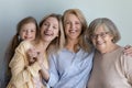 Happy little child, cheerful young mom, middle aged granny portrait Royalty Free Stock Photo