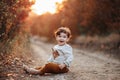 Happy little child, curly hair baby boy laughing and playing in the autumn on the nature walk outdoors Royalty Free Stock Photo