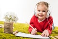 happy little child drawing with color pencils and listening music on green soft carpet Royalty Free Stock Photo