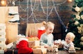 Happy little child dressed in winter clothing think about Santa near Christmas tree. Smiling child peeping from behind Royalty Free Stock Photo